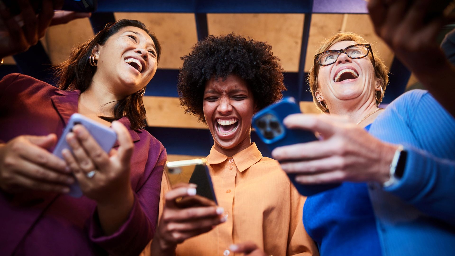 women taking a quiz and laughing